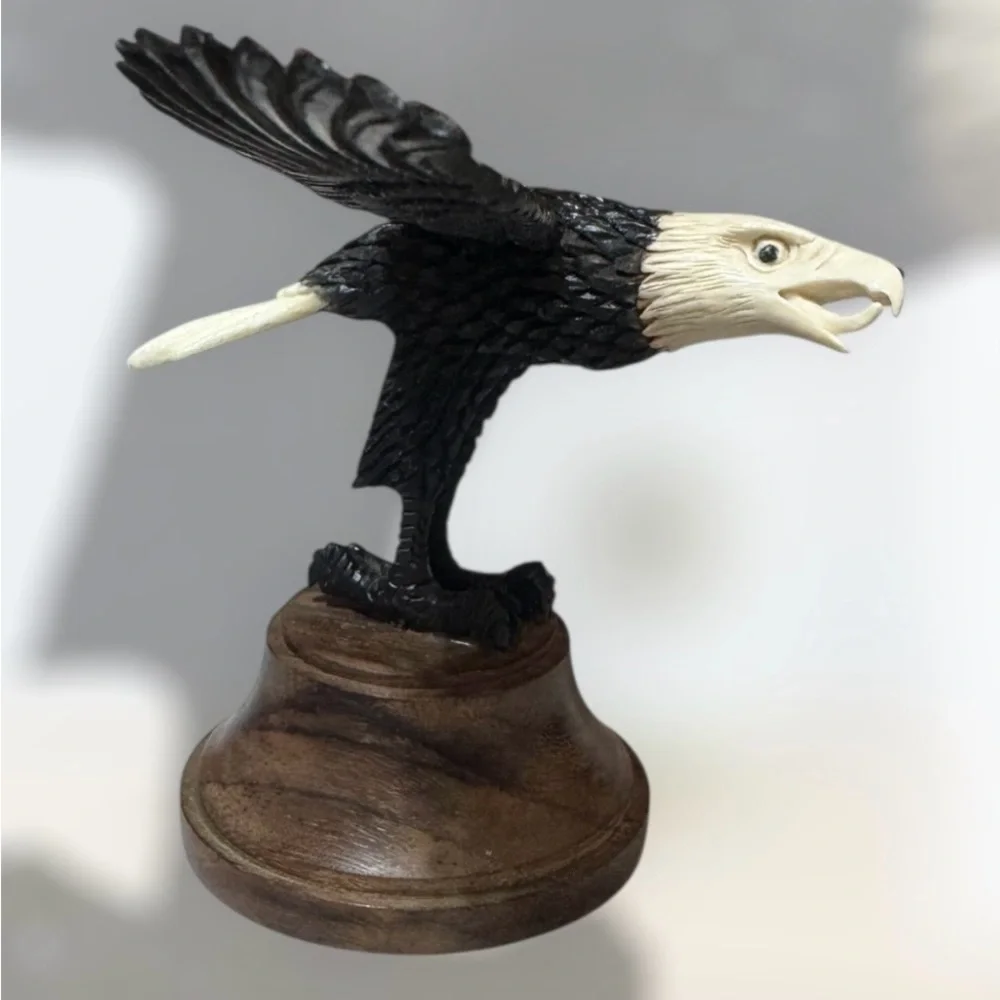 Alaskan bone carved eagle in flight on wood base 4”